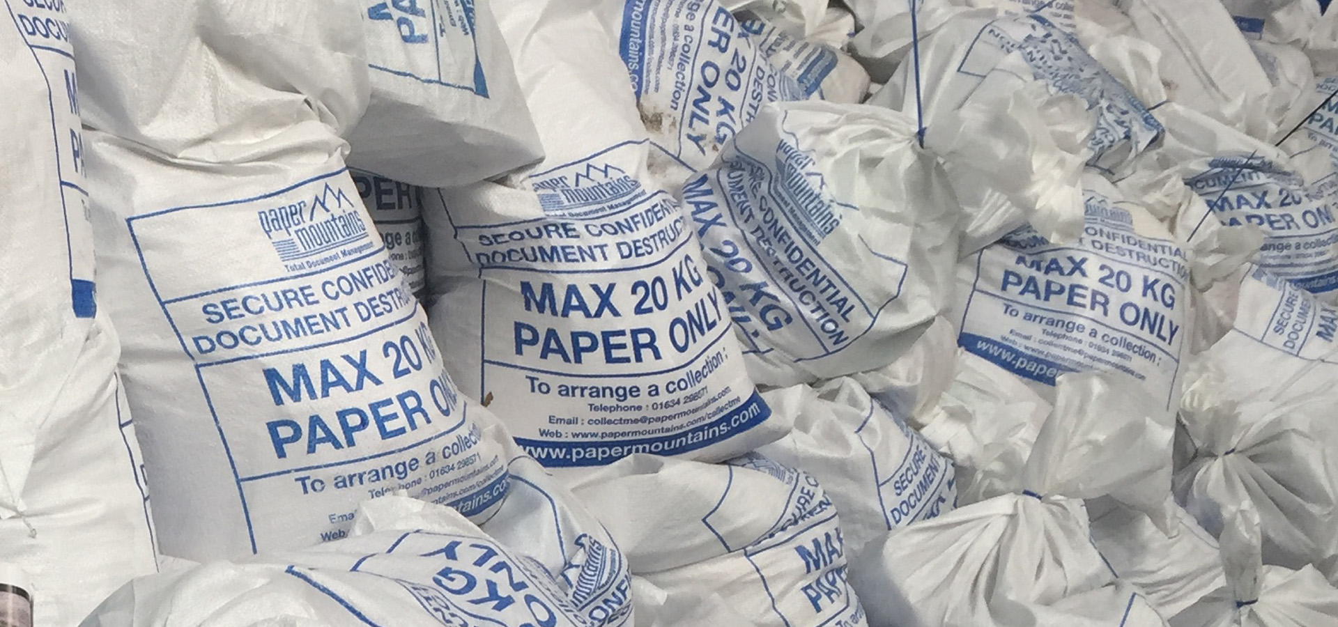 A large pile of secure sacks filled with paper ready to use our bulk shredding service