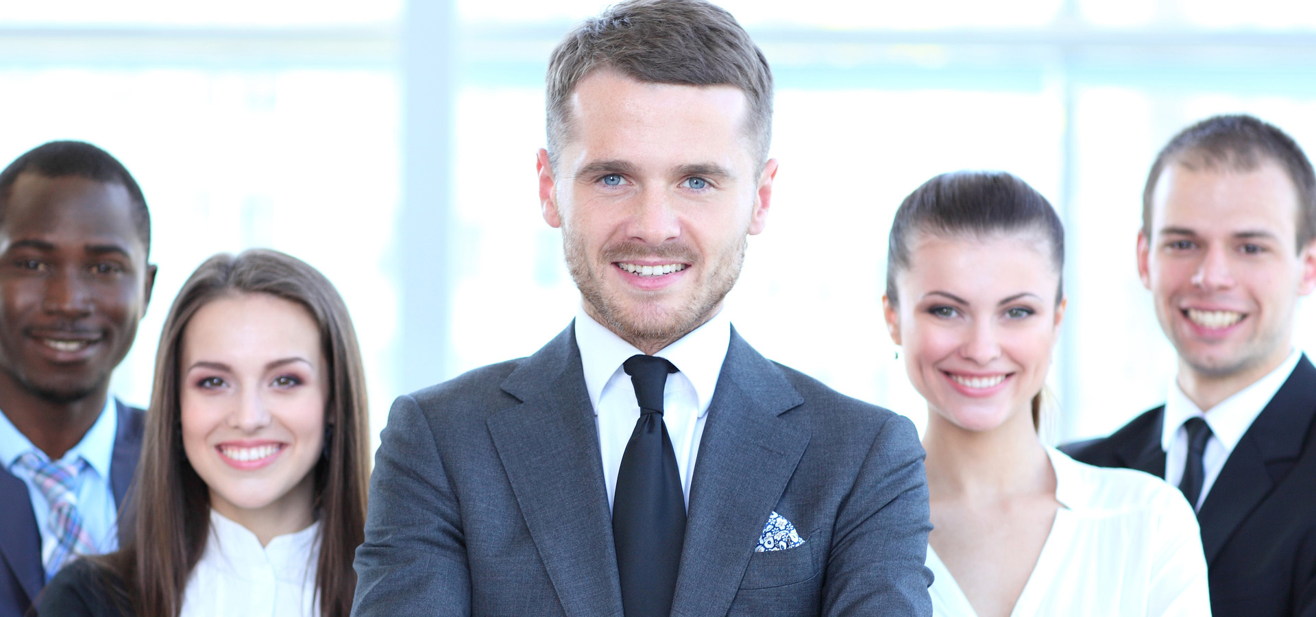 happy employees in a modern office, facing the camera