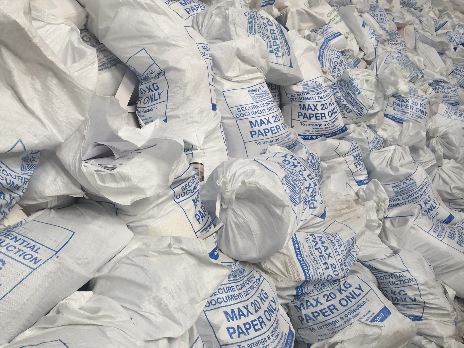 A large pile of sacks containing confidential waste paper ready to be shredded - a mountain of paper for PaperMountains
