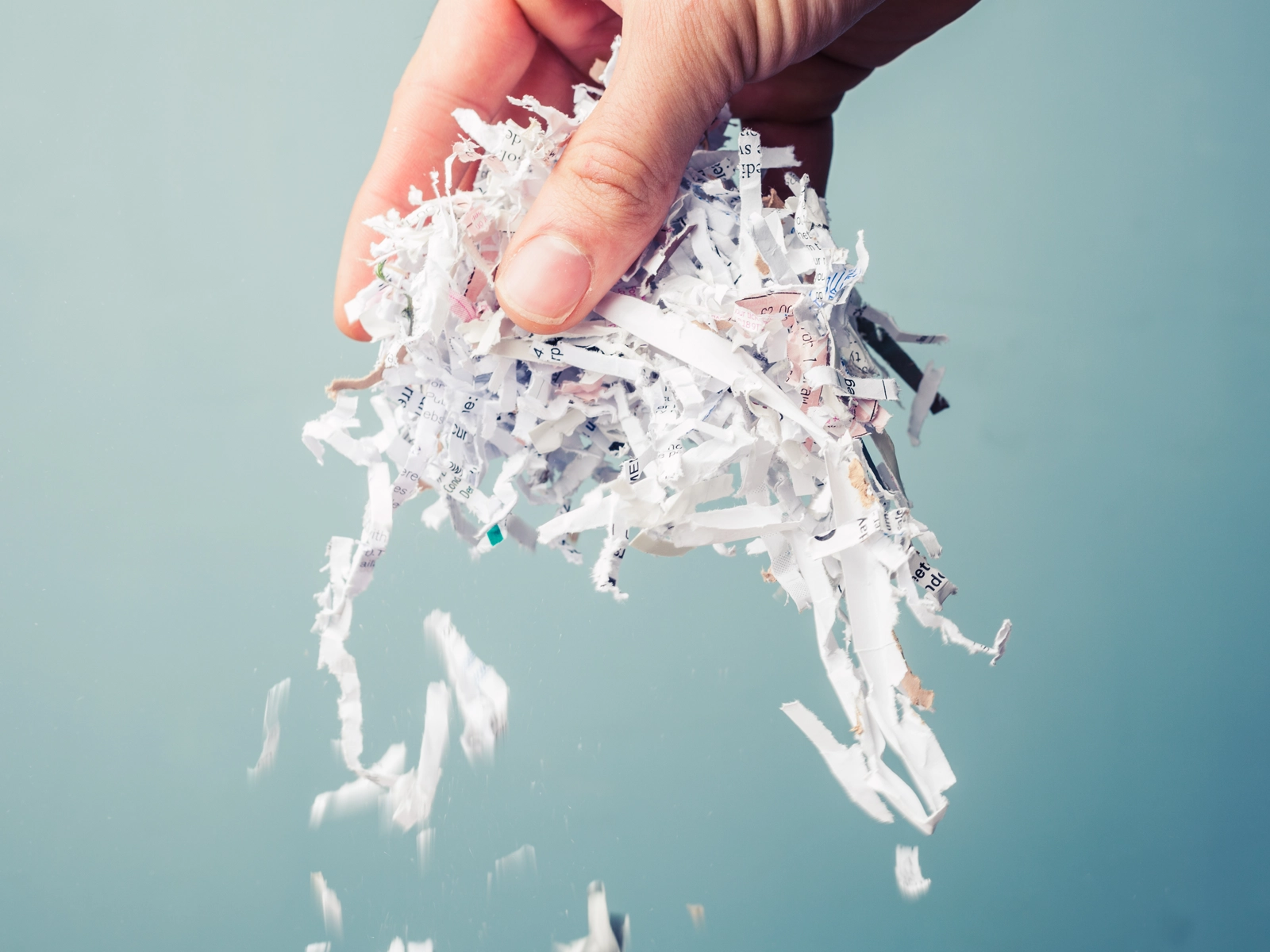 GDPR Compliant shredded paper being held in an hand implying one off secure shredding services