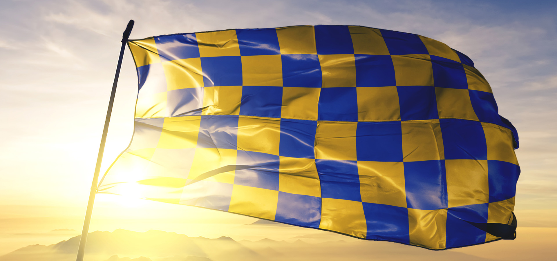 Surrey flag flying in front of sun, conveying the message that PaperMountains services clients across Surrey for one off and regular collections of paper and hard drives for secure shredding.
